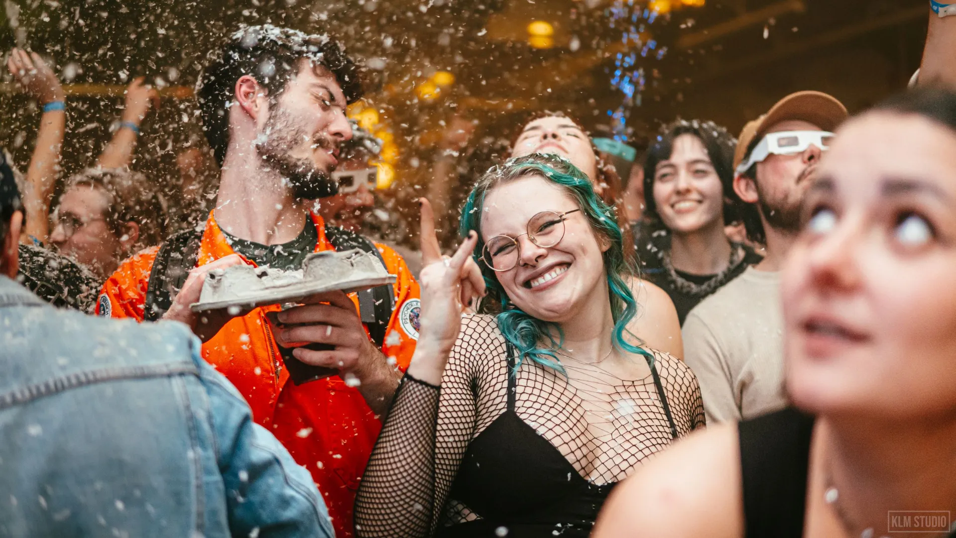 Crowd celebrating under confetti at a party